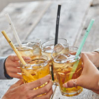 屋外でストローでドリンクを飲む